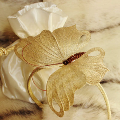 Golden fascinator with a butterfly