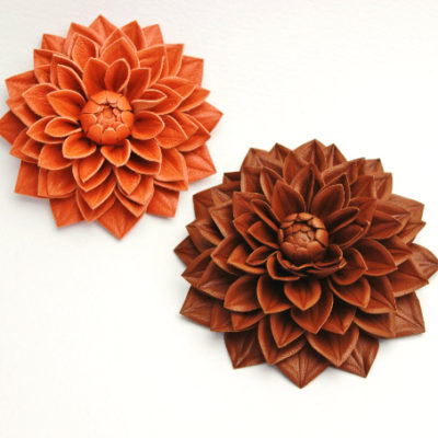 orange and brown leather flower brooches